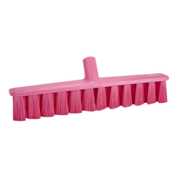 A close-up of a Vikan pink broom head with medium bristles.