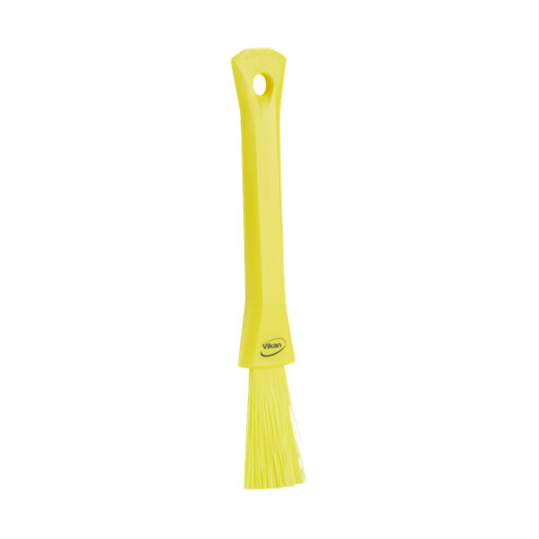A yellow Vikan detail brush with a handle.