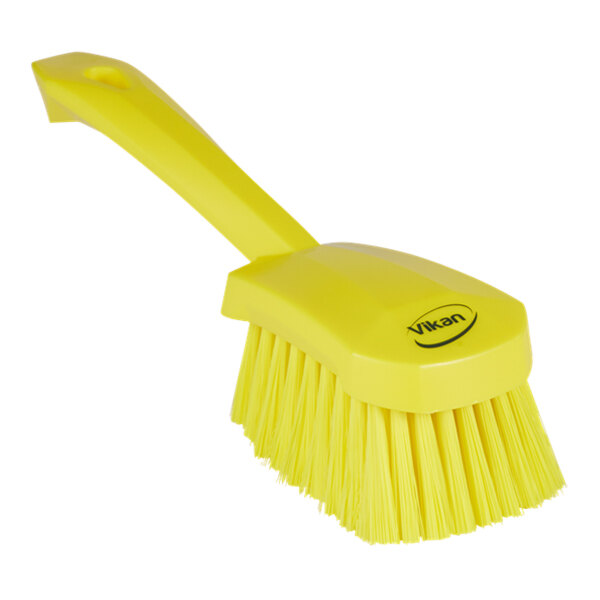A close-up of a yellow Vikan washing brush with a handle.