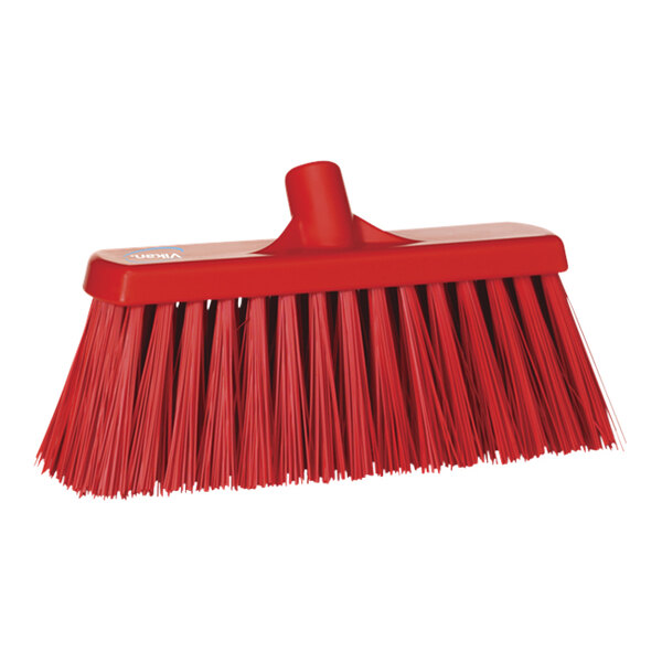 A red Vikan push broom head with long bristles.