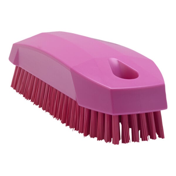 A pink Vikan hand and nail brush with a handle.