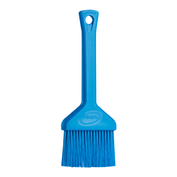 A close-up of a Vikan blue pastry brush with a plastic handle.