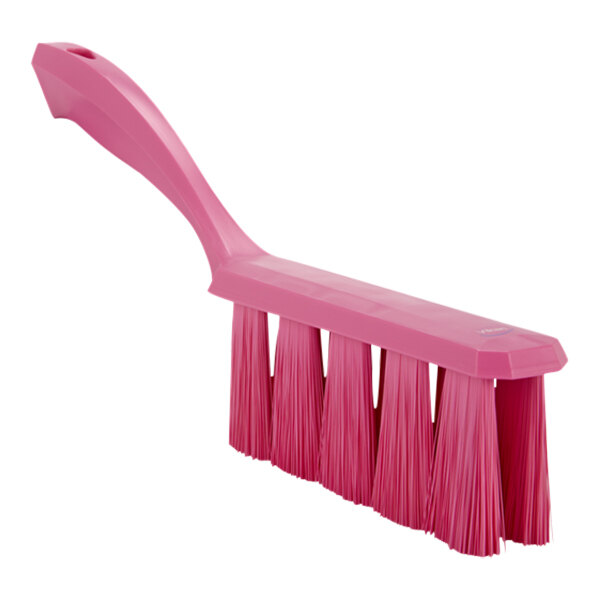 A close-up of a Vikan pink bench brush with medium bristles.