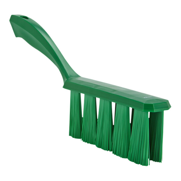 A close-up of a green Vikan bench brush with medium bristles.