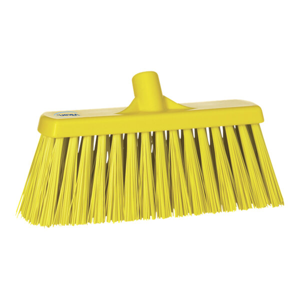 A yellow Vikan push broom head with long bristles.