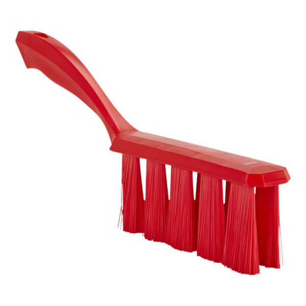 A red brush with long red bristles.