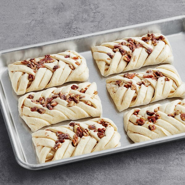 A tray of Gourmand Maple Pecan Braided Danish pastries on a table.