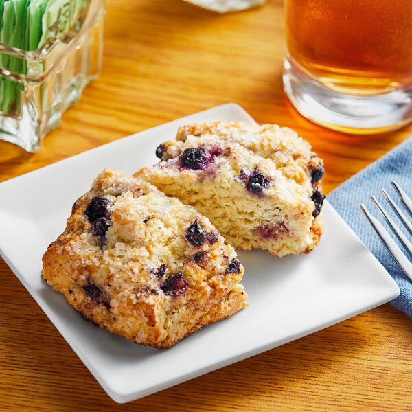 Individually wrapped blueberry scone on a plate.