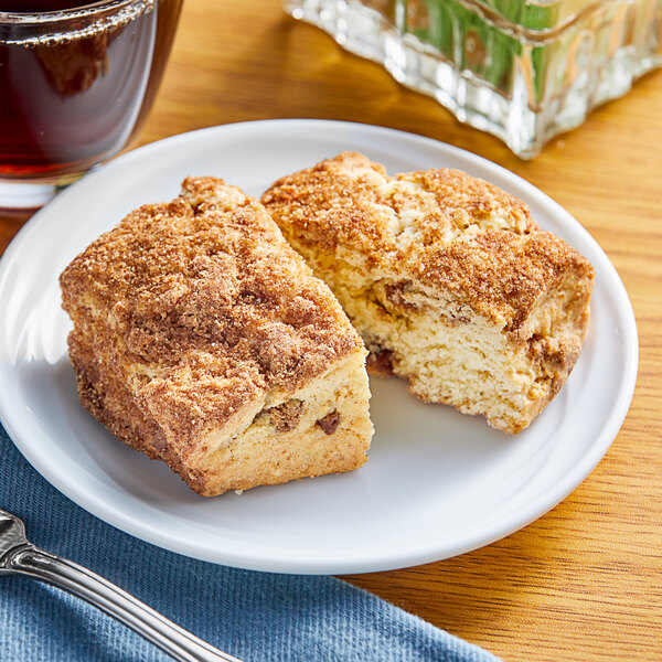 A plate with two pieces of Sweet Street Desserts Cinnamon Scones on a table.