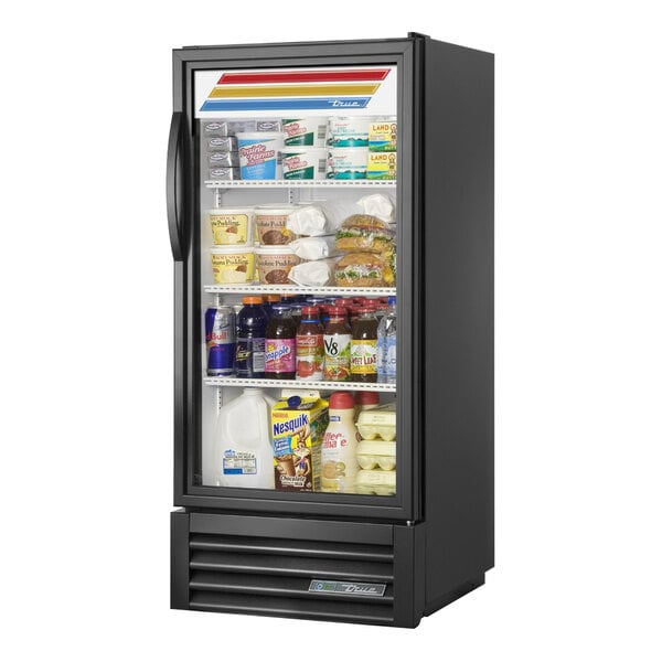A True black refrigerated glass door merchandiser full of food with a white plastic container with a blue label inside.