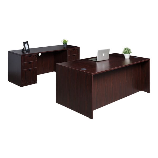 A Boss mahogany laminate desk with dual storage pedestals and a laptop on top.
