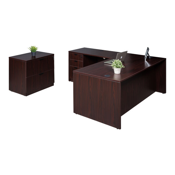 A Boss mahogany laminate desk with return, lateral storage, and storage pedestal under a window.