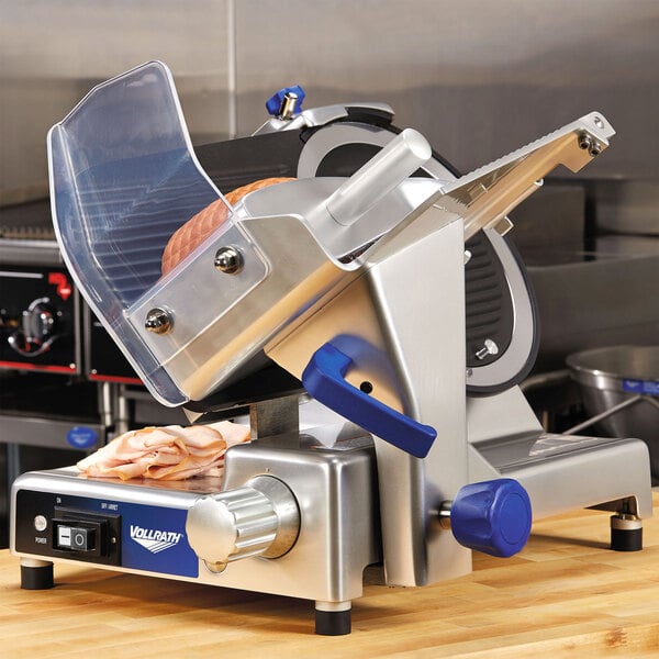 A Vollrath meat slicer on a counter.