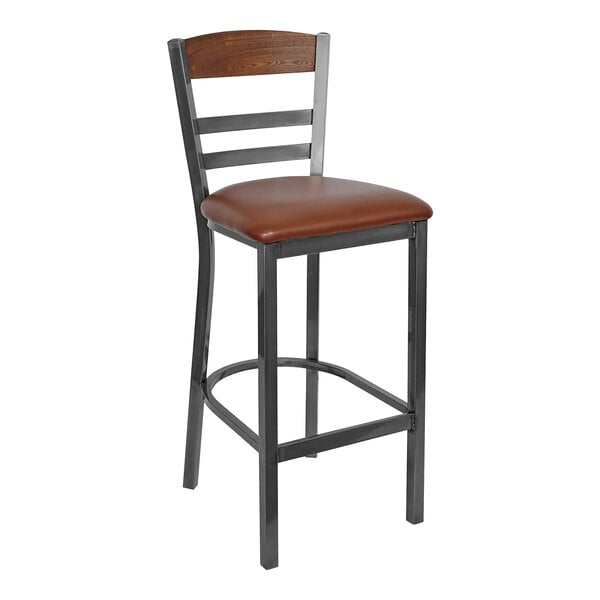 A BFM Seating steel barstool with a light brown vinyl seat and autumn ash wood back panel.