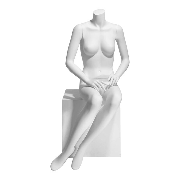 A white Econoco Eve female headless seated mannequin with hands on lap sitting on a white block.