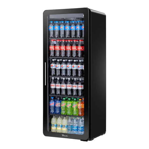 A True black refrigerated glass door merchandiser filled with bottles of soda.