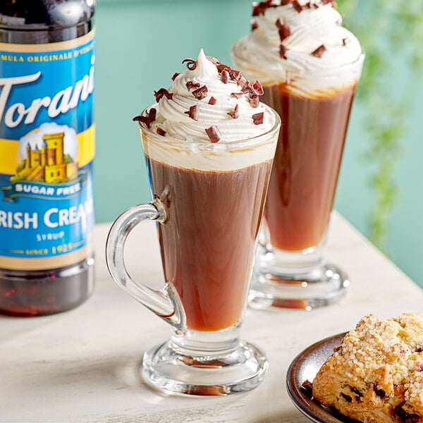 A cup of coffee with Torani Sugar-Free Irish Cream flavoring and cookies on the side.