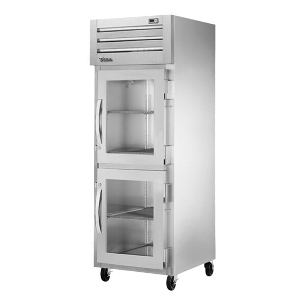 A white True reach-in freezer with glass half doors.