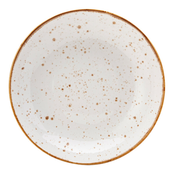 A white Tuxton china salad bowl with brown speckles.