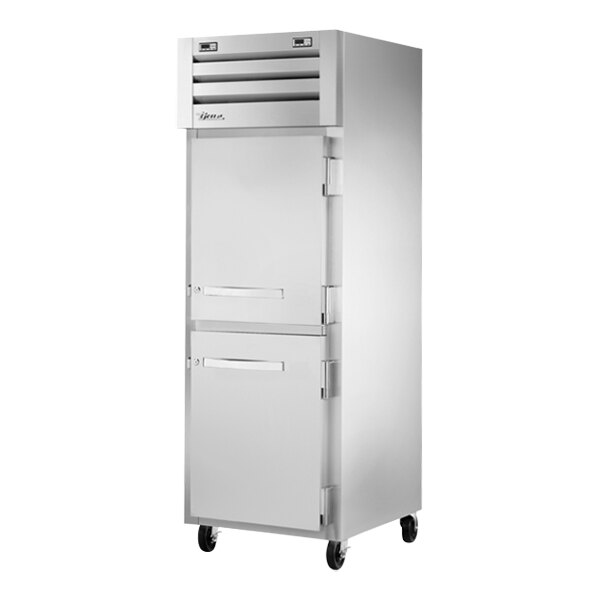 A True commercial combination refrigerator and freezer with white and silver handles.