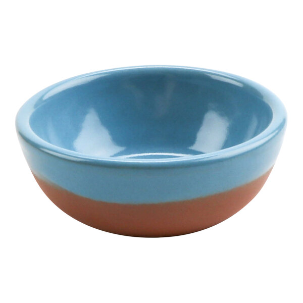 A close up of a blue and brown Cheforward by GET Graupera terracotta bowl with a white rim.