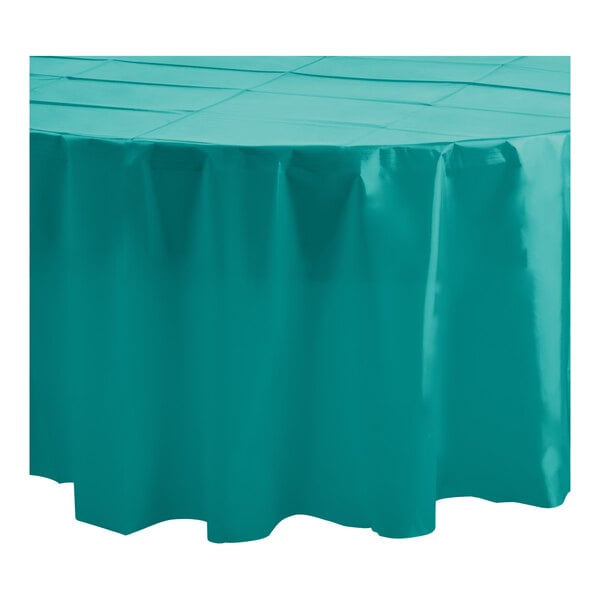 A white table with a Table Mate teal round plastic table cover on it.
