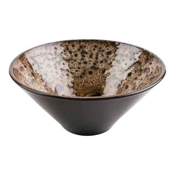 A cheforward terracotta bowl with a brown and white speckled surface.