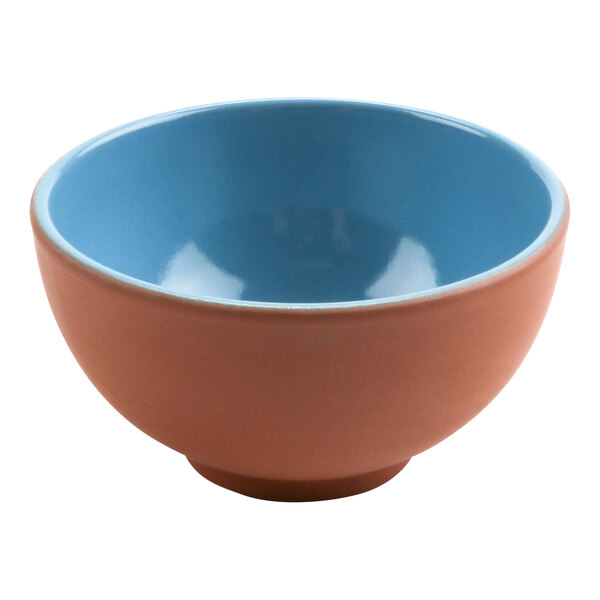 A blue terracotta bowl with a blue and pink rim.