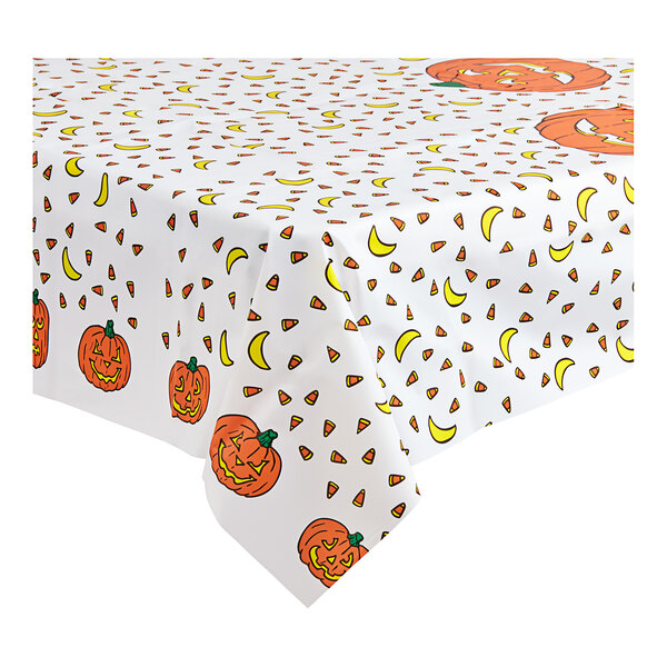 A Table Mate plastic tablecloth with a pattern of pumpkins and bananas.