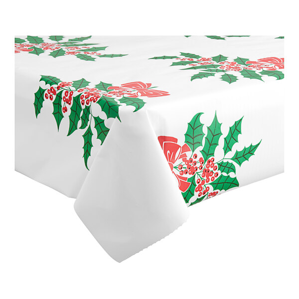 A white Table Mate tablecloth with red and green holly leaves and berries.