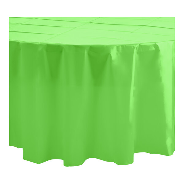 A lime green Table Mate plastic tablecloth on a round white table.