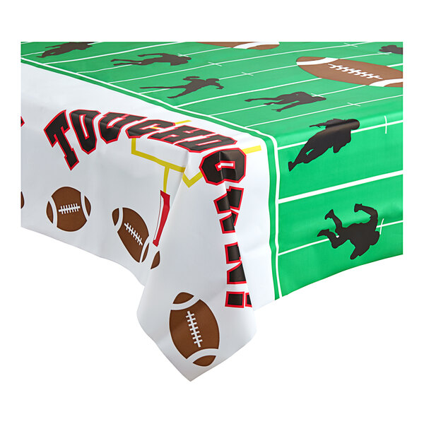A Table Mate plastic table cover with footballs and sports images.