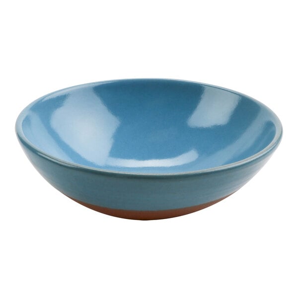 A blue terracotta bowl with brown rim.