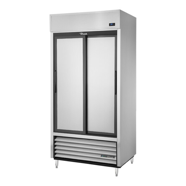 A True 2 section sliding solid door reach-in refrigerator.