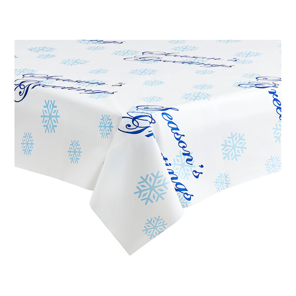 A white Table Mate plastic table cover with blue snowflakes and "Season's Greetings" text.
