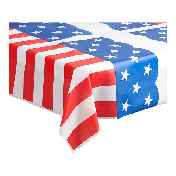 A white plastic table cover with red and blue stars and stripes on a table.