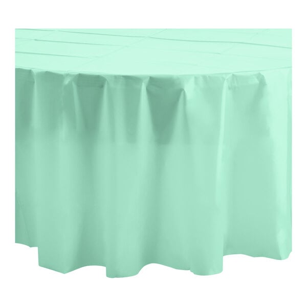A round table with a mint green Table Mate tablecloth.