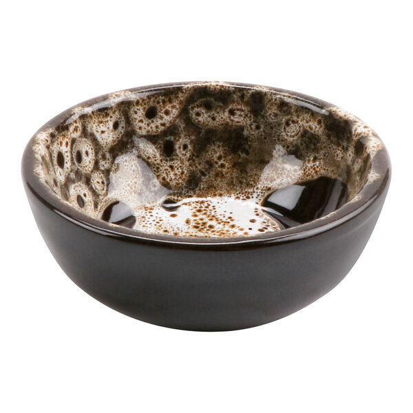 A cheforward terracotta bowl with a white and brown speckled surface.