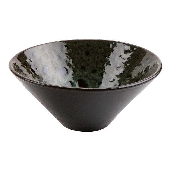 A black cheforward terracotta bowl with a speckled surface.
