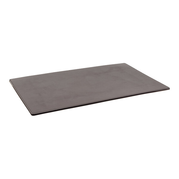 A black rectangular Room360 London faux leather desk pad on a table.