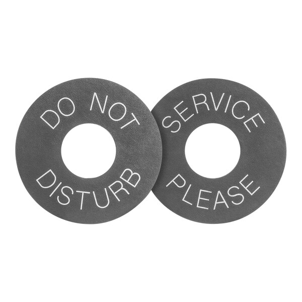 A round black faux leather door hanger with a close-up of a black and white service sign on it.