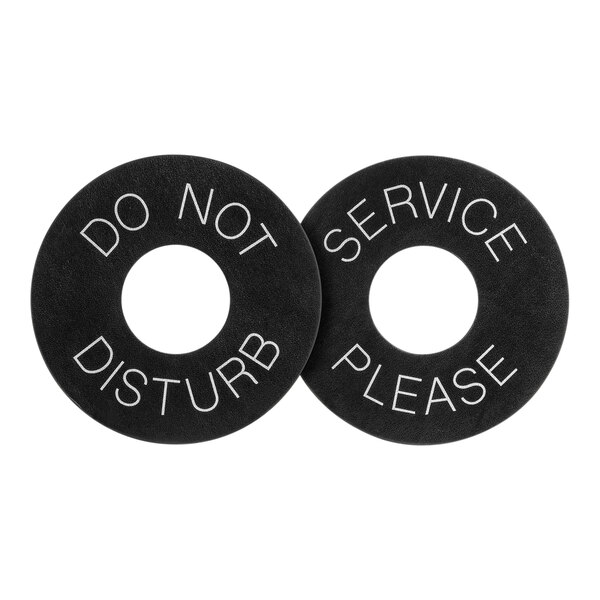 A close-up of a black circle with white text reading "Do not service" and "Please"