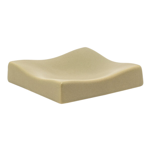 A white square ceramic soap dish with curved edges.
