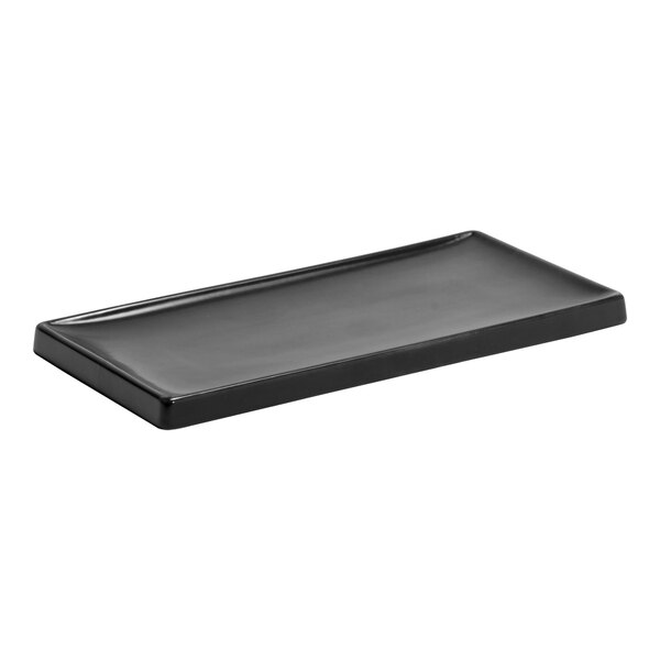 A black rectangular Room360 amenity tray with a brown composite stone finish.