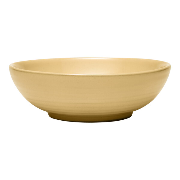 A close up of a Libbey tan terracotta stoneware bowl on a white background.