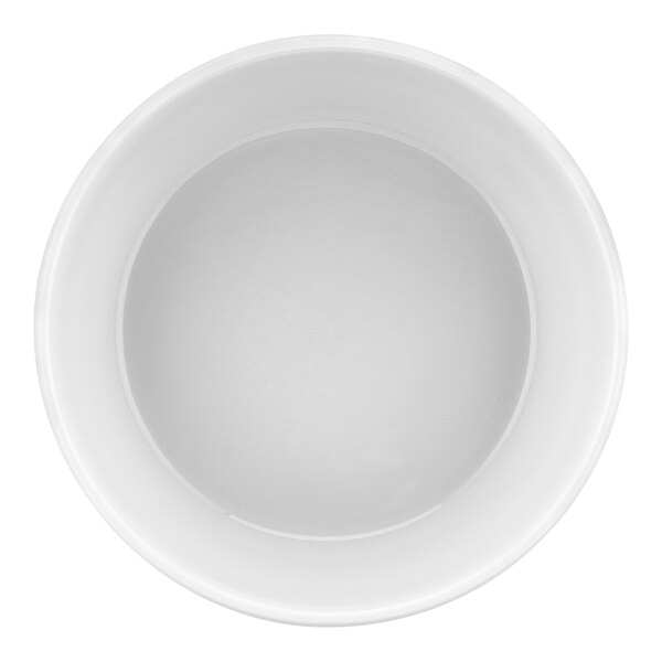 A white round porcelain souffle dish with a white surface.
