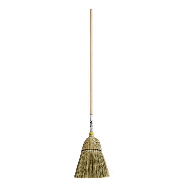 A small authentic Amish-made corn broom with a wooden handle.