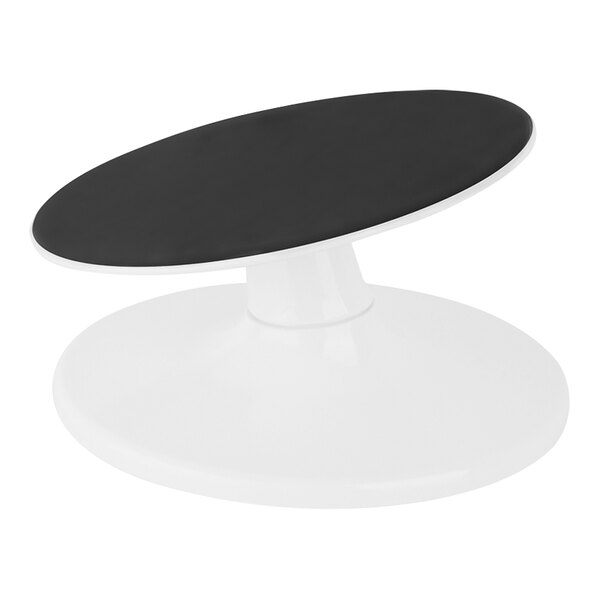 A black and white Matfer Bourgeat cake turntable on a white table.