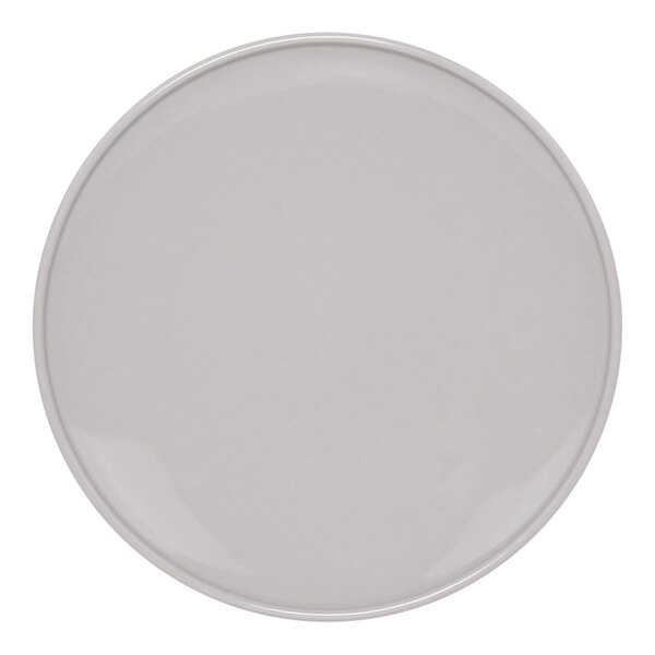 A close up of a white Front of the House stone porcelain plate with a round border.