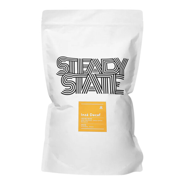 A white bag of Steady State Roasting Inza Single Origin Decaf Whole Bean Coffee with a yellow label and black and white text.